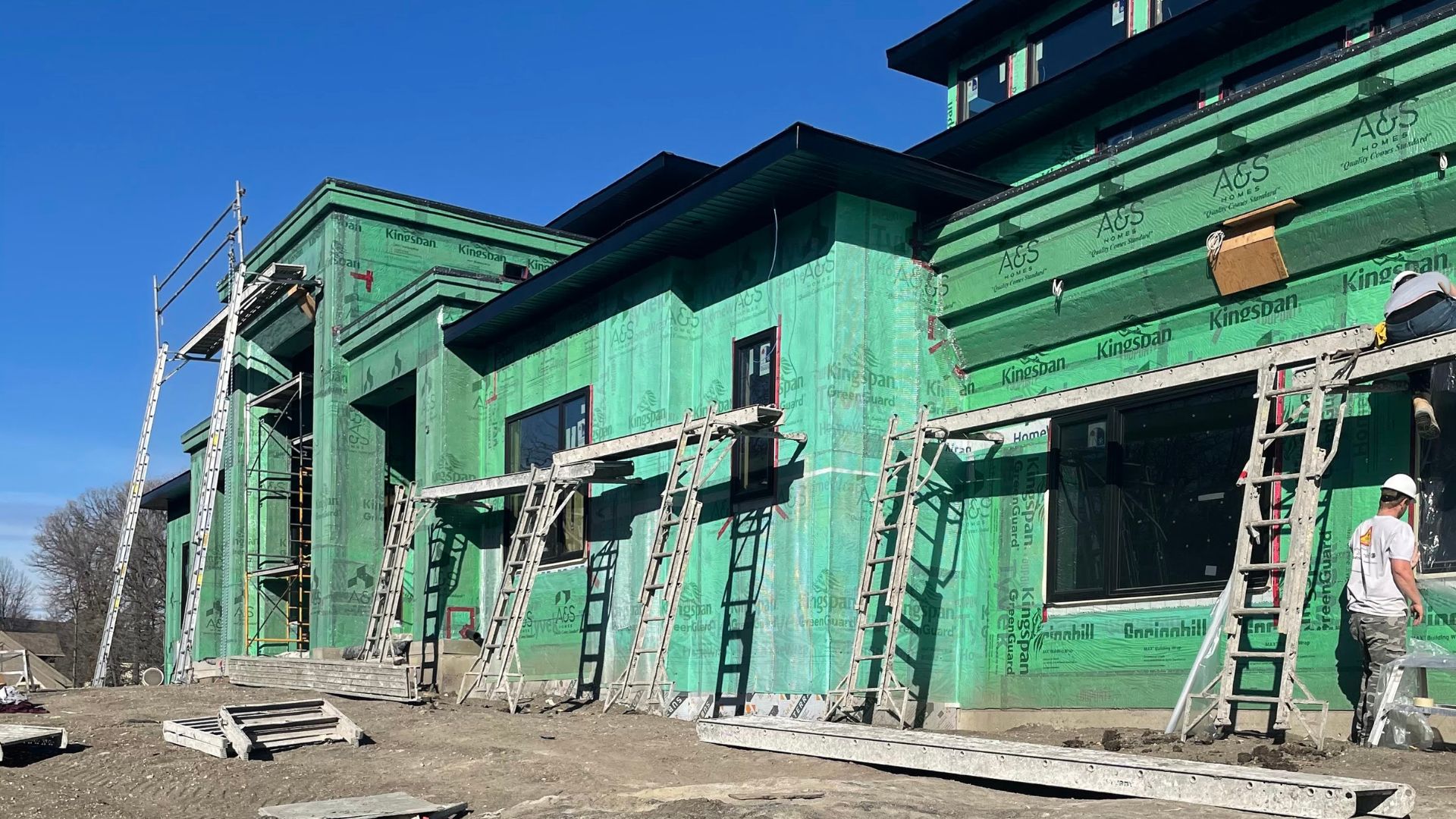 In progress building with siding in the process of completion